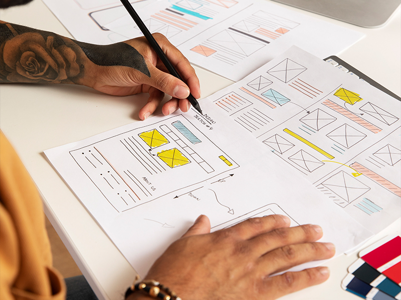 web designer drawing draft mockups for website creation